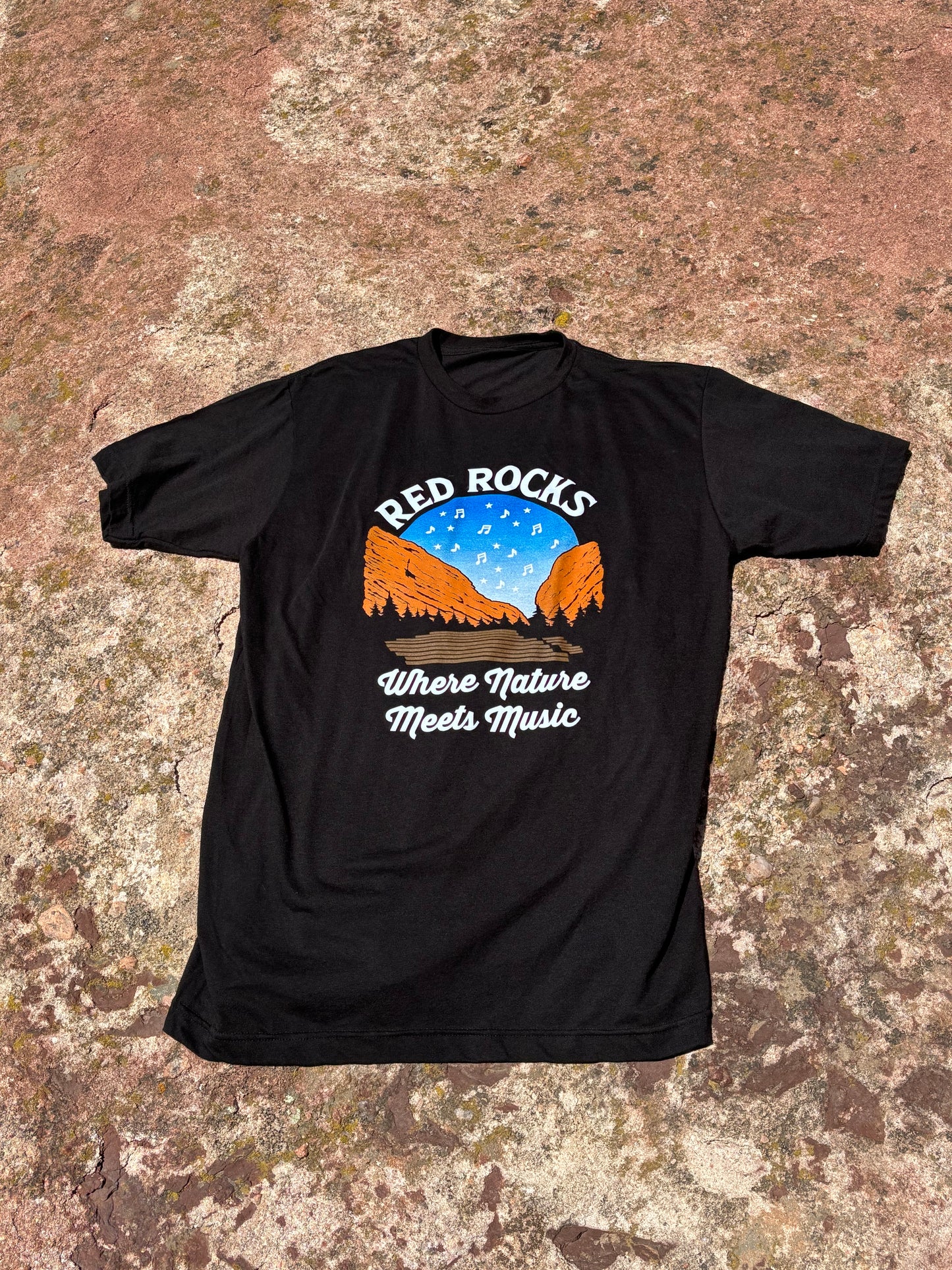Black t-shirt with a graphic design on a textured surface